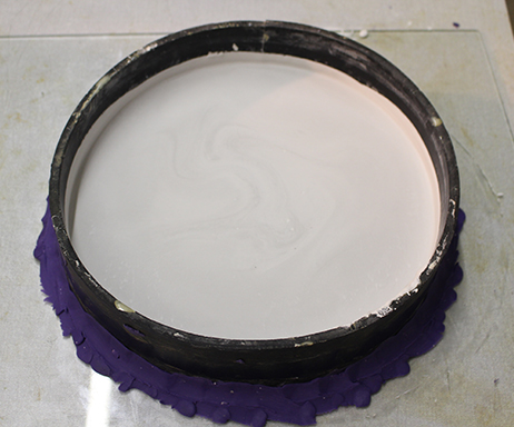 The negative plaster is coated with soft soap and then plaster is poured on to create a positive version