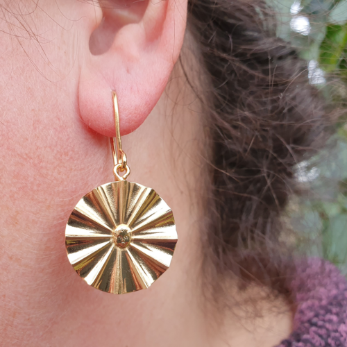 SunChild earring. A vermeil fan with the tiny face of a sunchild in the centre.